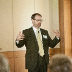 A man gestures at the front of a room